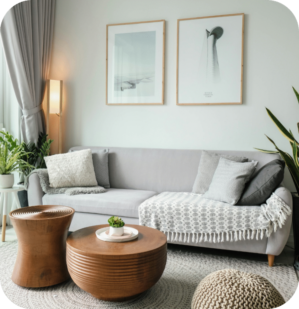 A gray sofa with a wooden coffee table.