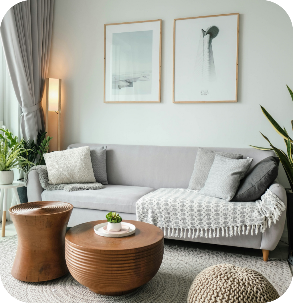 A gray sofa with a wooden coffee table.