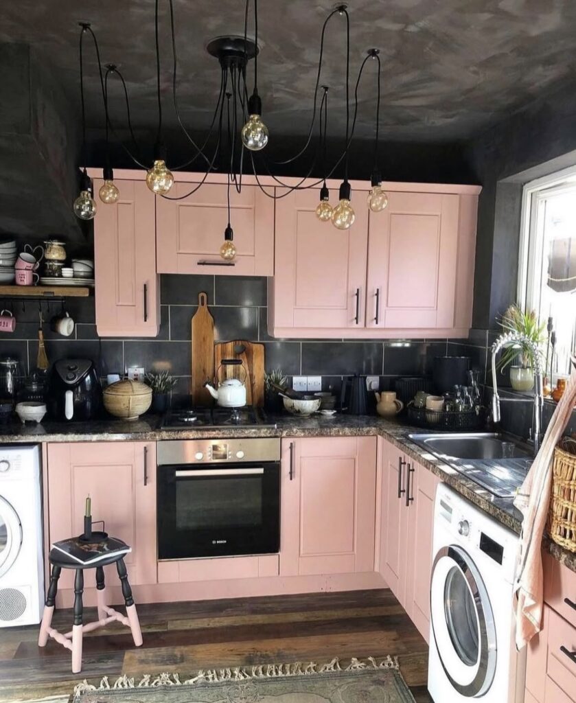 A pink kitchen cabinet in a black kitchen.