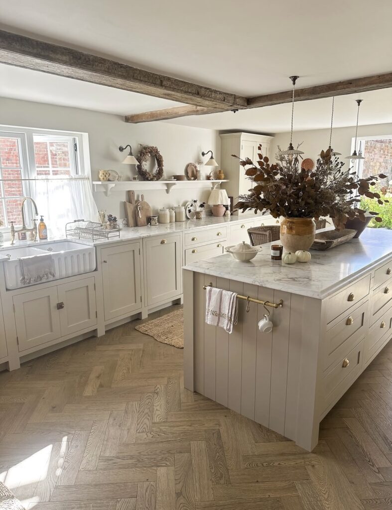 A white kitchen cabinet with wooden beams.