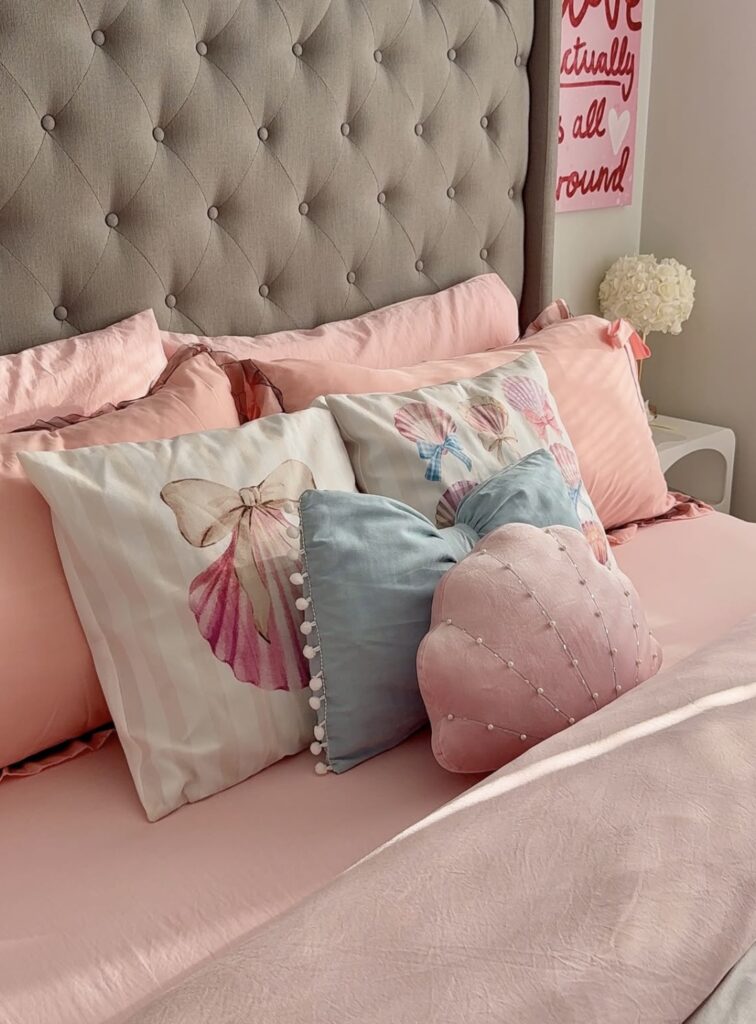 A pink bed with coastal accessories.
