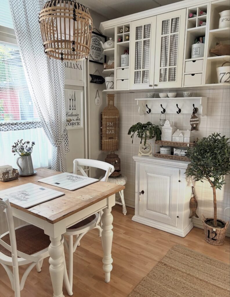 A white kitchen cabinet with farmhouse signs.