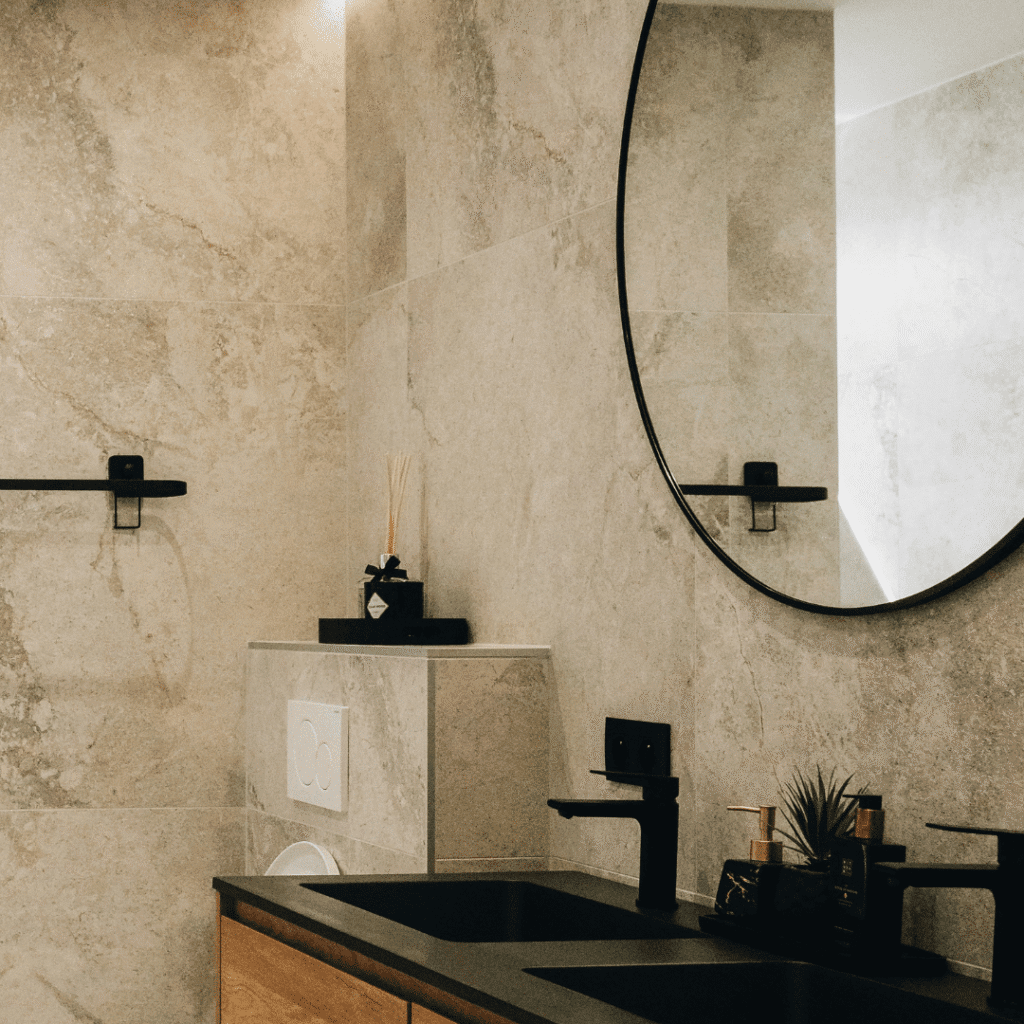 A bathroom with a black mirror.