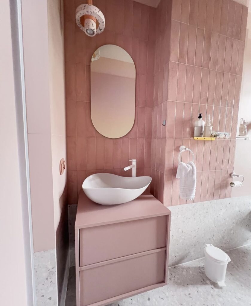 A modern bathroom with muted pink.