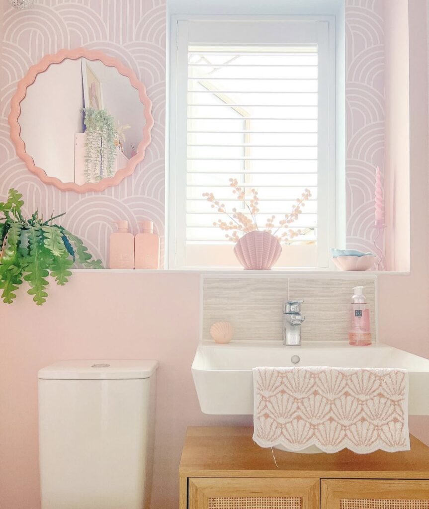 A modern bathroom with light pink.