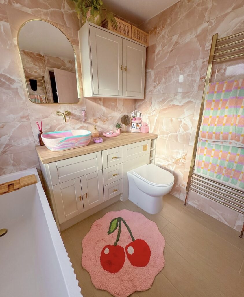 A bathroom with pink marble.