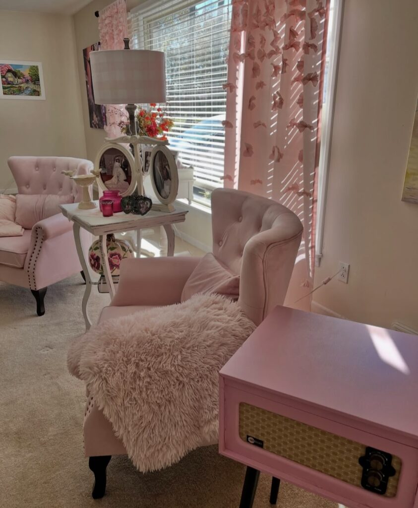 Two pink antique chairs in a living room.