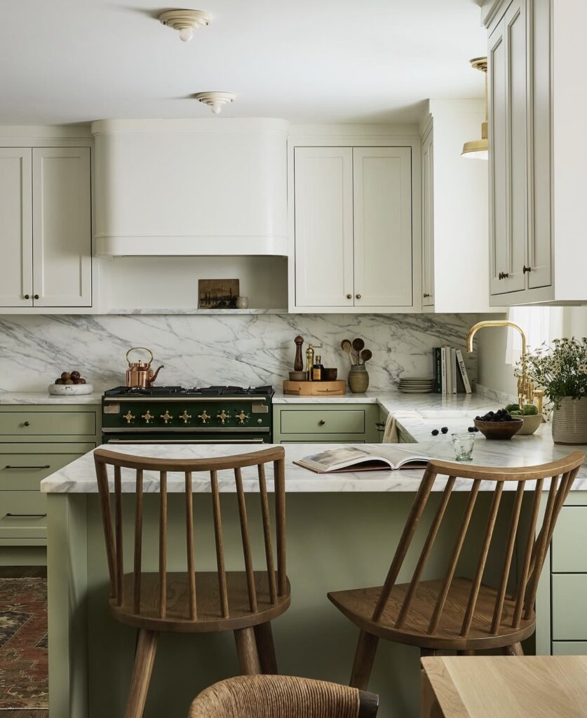 A sage green kitchen cabinet with an oriental rug.