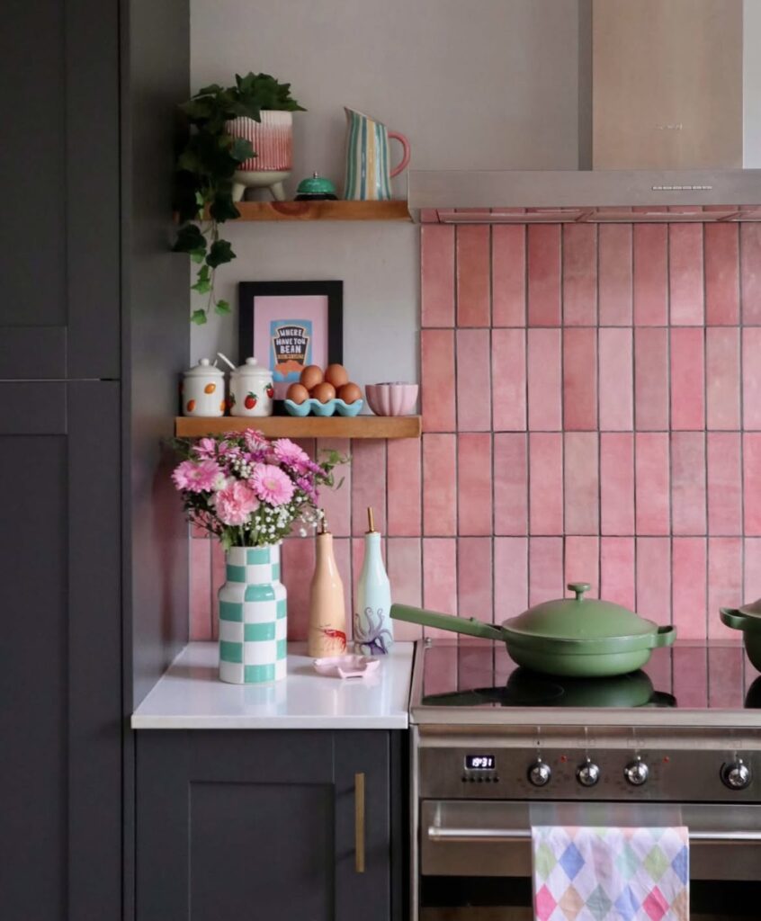 A gray kitchen with pink tiles.