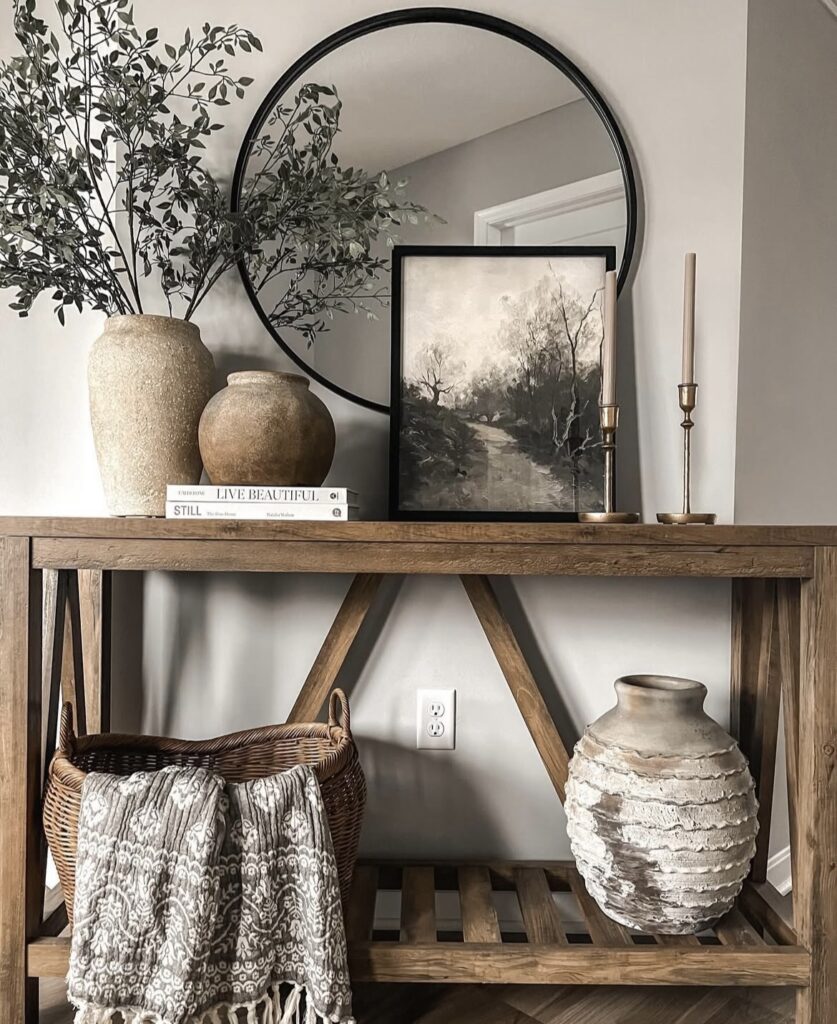 A traditional entryway with a wooden console table and ceramic vases.