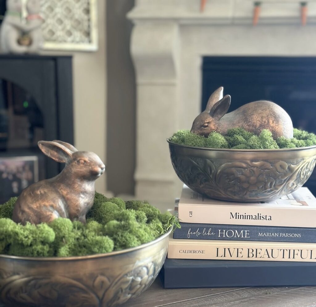 Brass bunny figurines in moss bowls.
