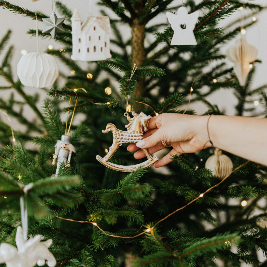 A woman holding a horse ornament.