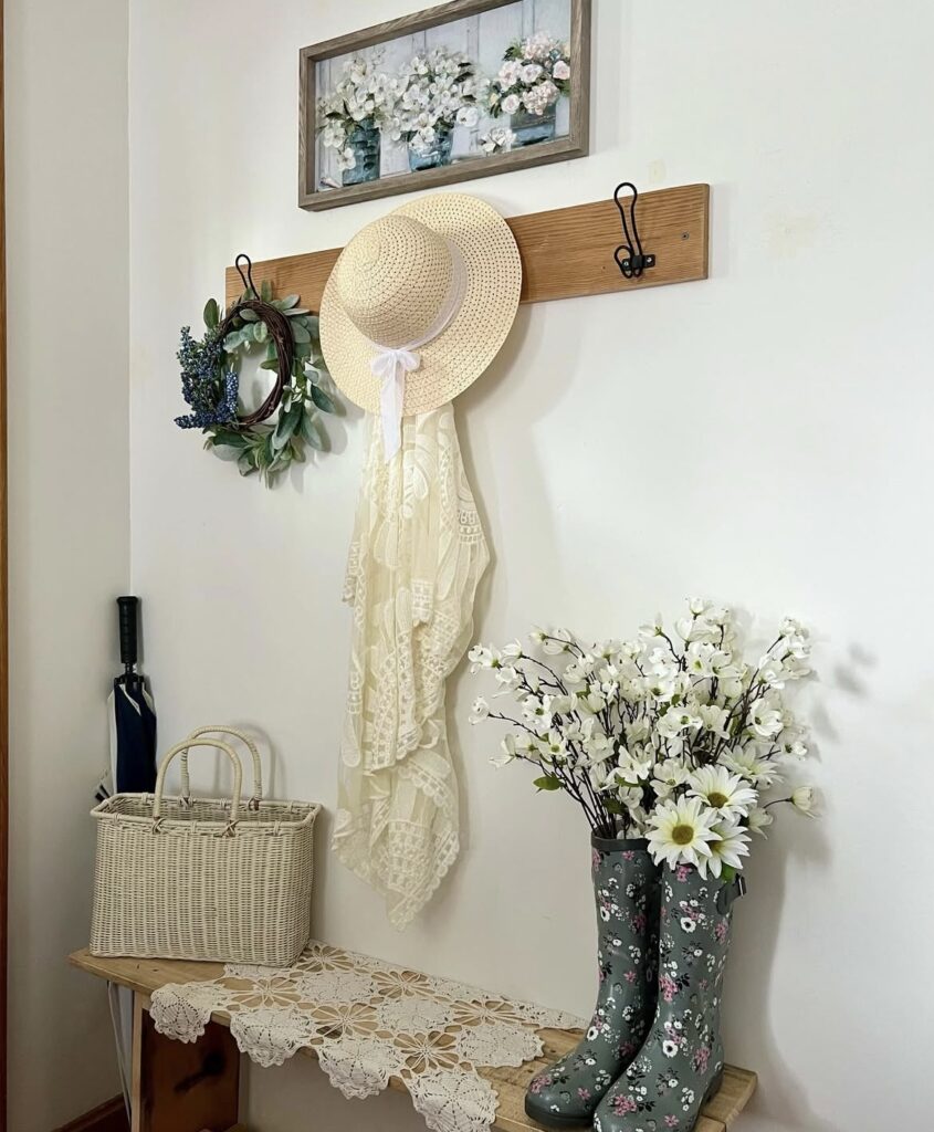 A farmhouse entryway with floral prints, wreaths, and vases.