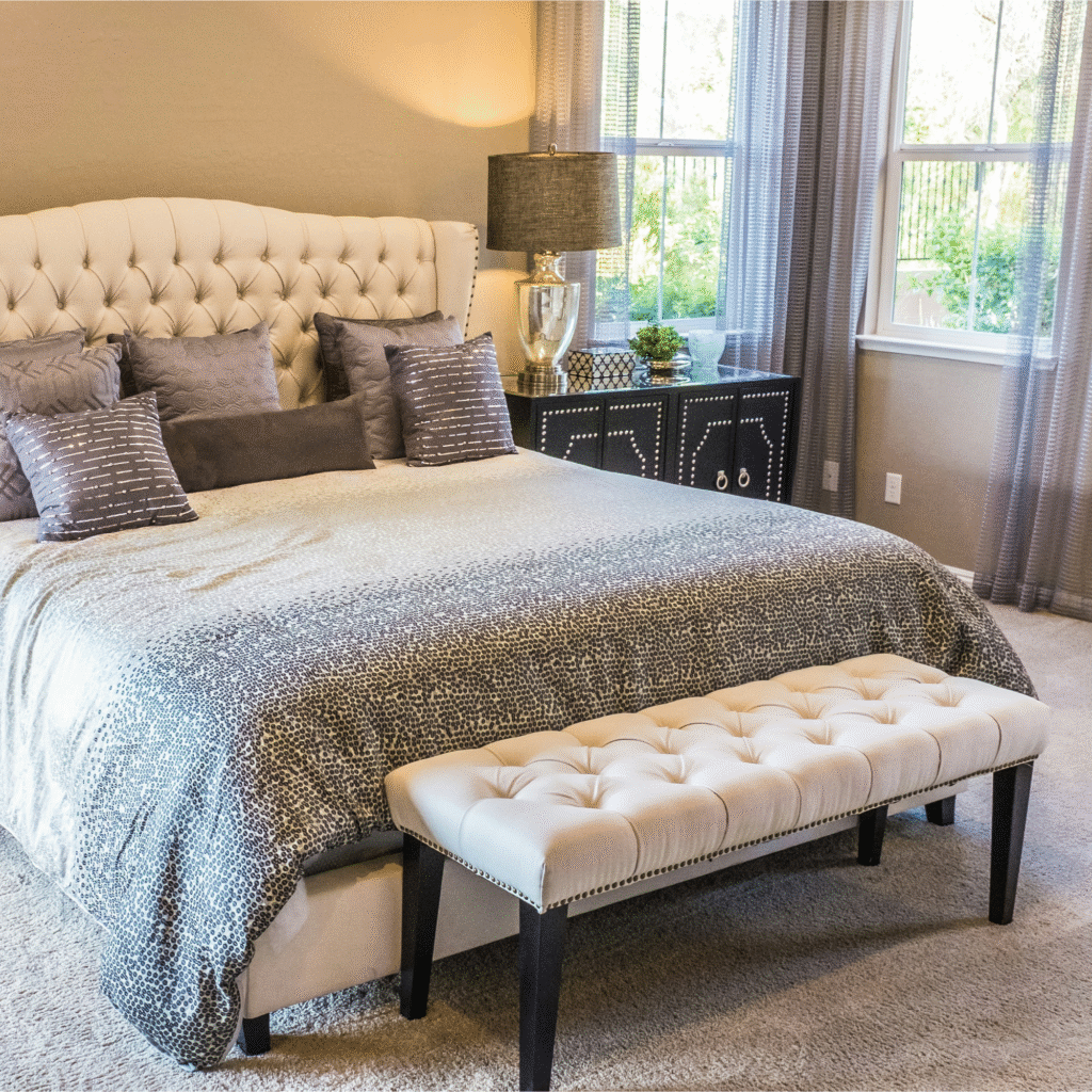 A bedroom with a cushion bench.