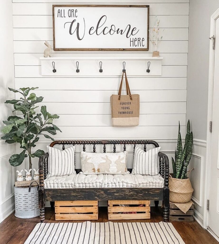 A farmhouse entryway with a welcome sign.