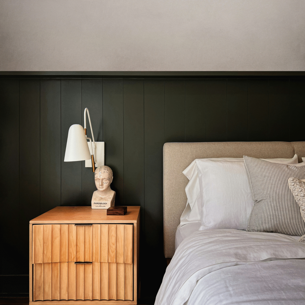 A modern bedroom with half wall paneling.