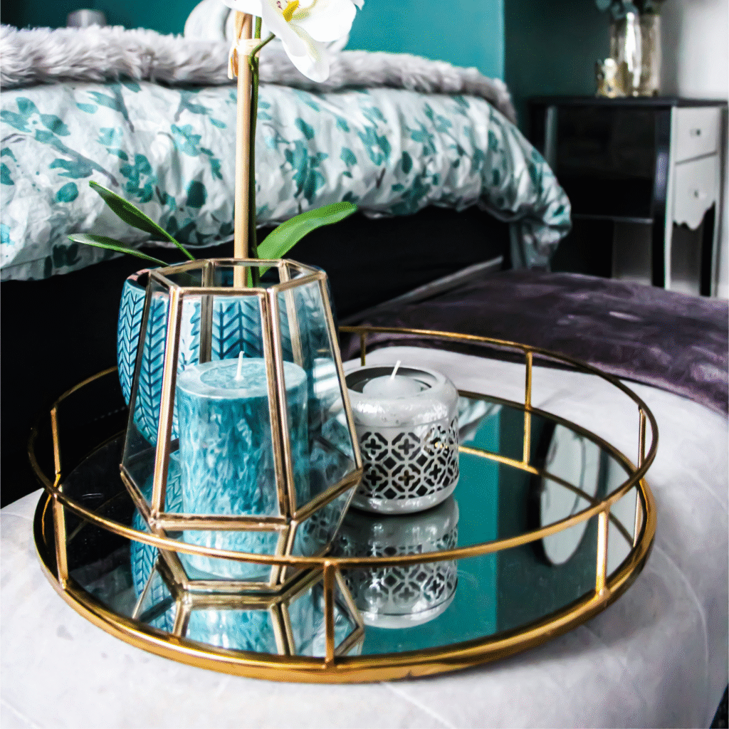 A gold mirror tray in a bedroom.