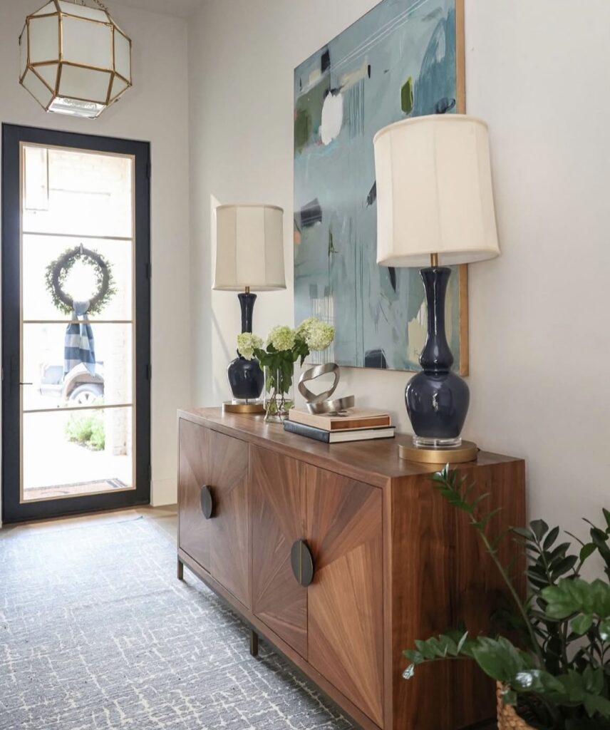 A modern entryway with a large blue painting.