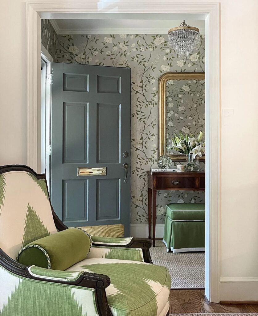 A traditional entryway with floral wallpaper.