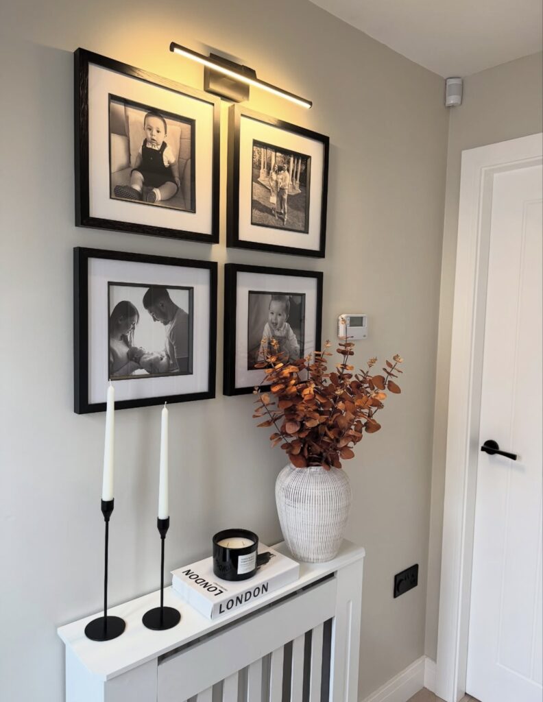 A modern entryway with personal photographs.
