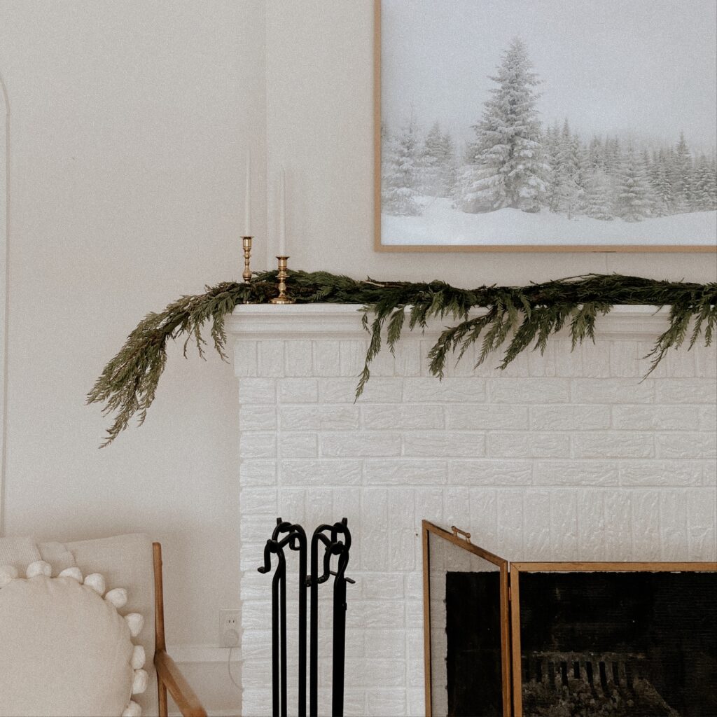 A pine branch garland on a mantel.