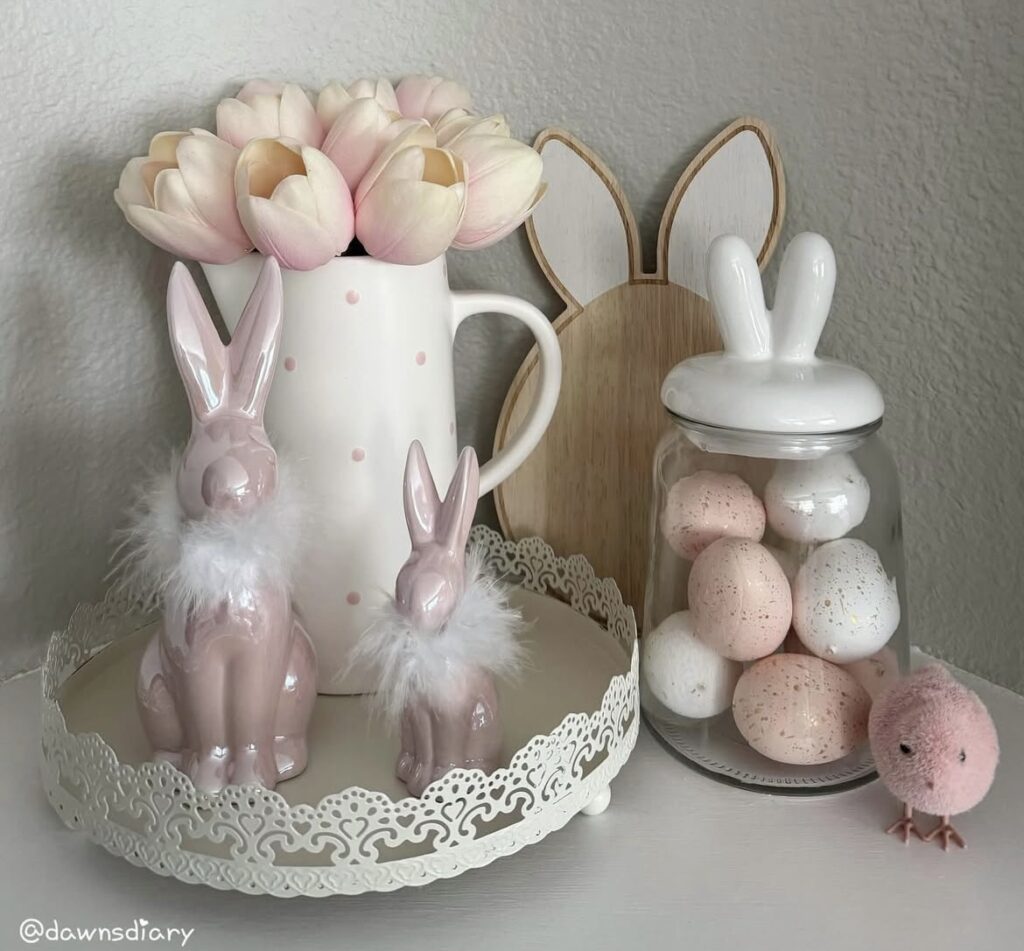 Pink bunny figurines with pink Easter eggs.