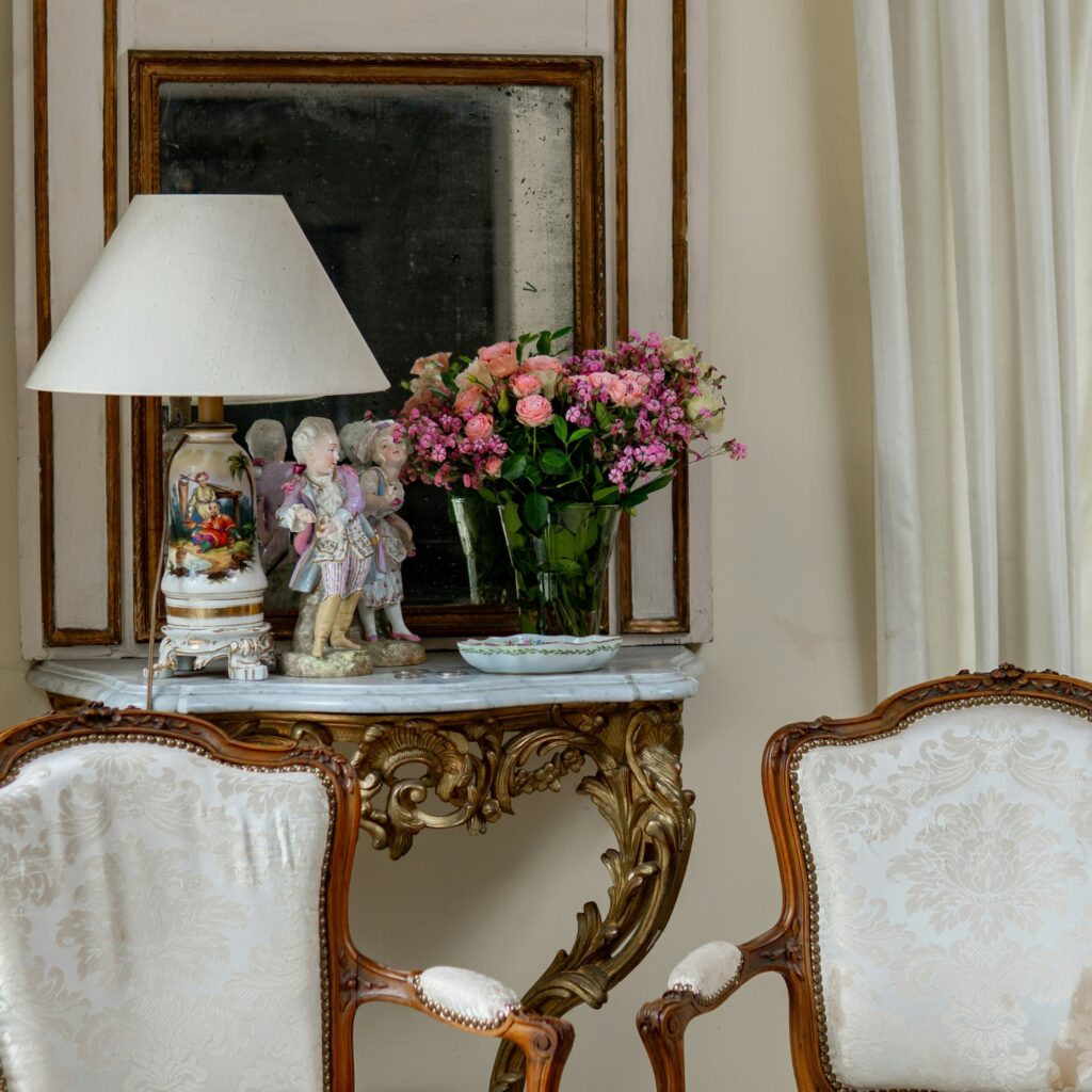 An antique living room with flowers.