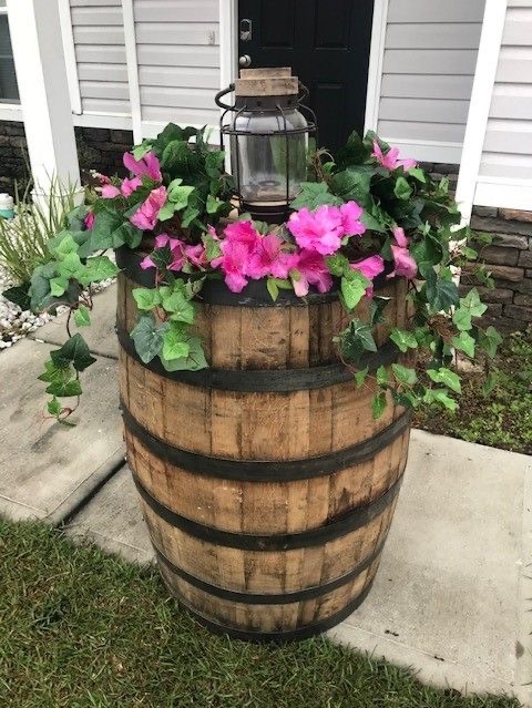 A rustic barrel with flowers.