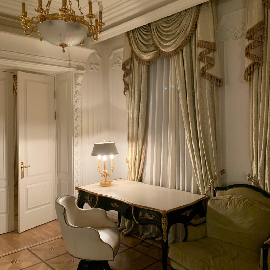 An antique neutral and sage green living room.