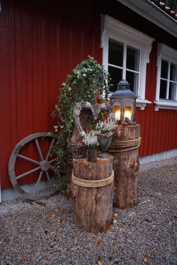 Wooden logs with candles lanterns and planters.