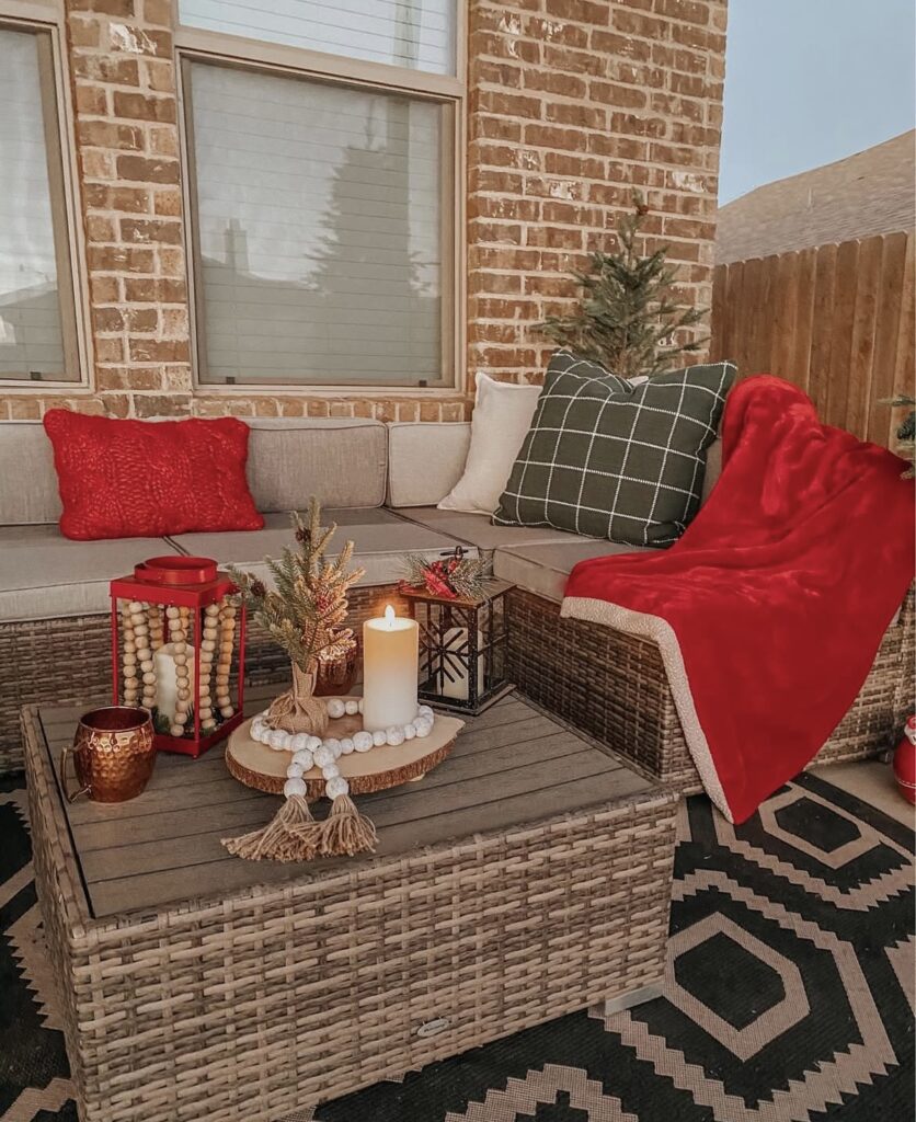 A woven porch table with candle lanterns.