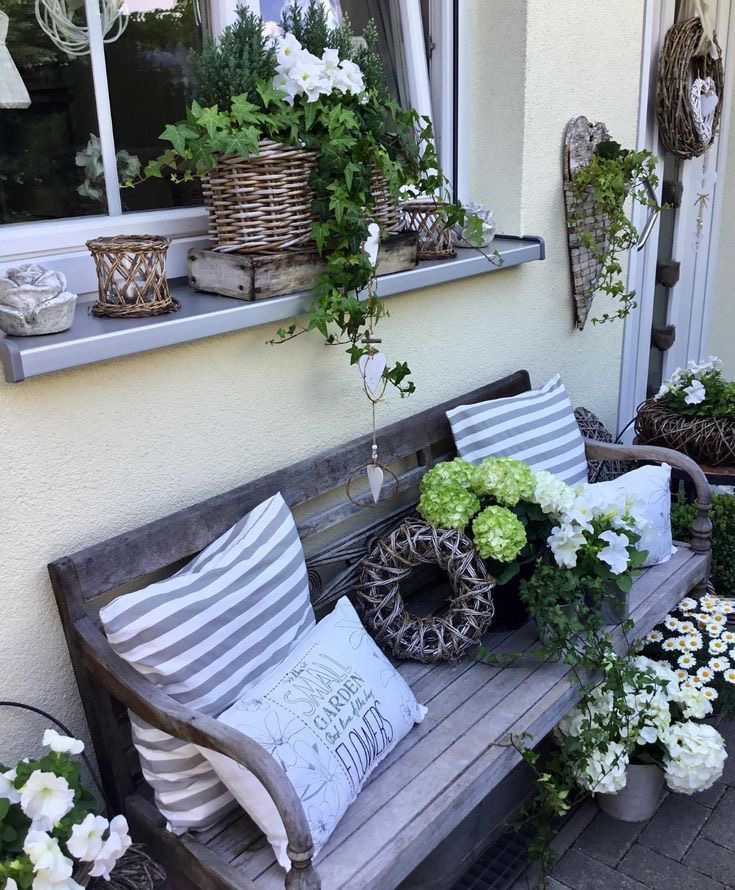 A wooden bench with cozy pillows.
