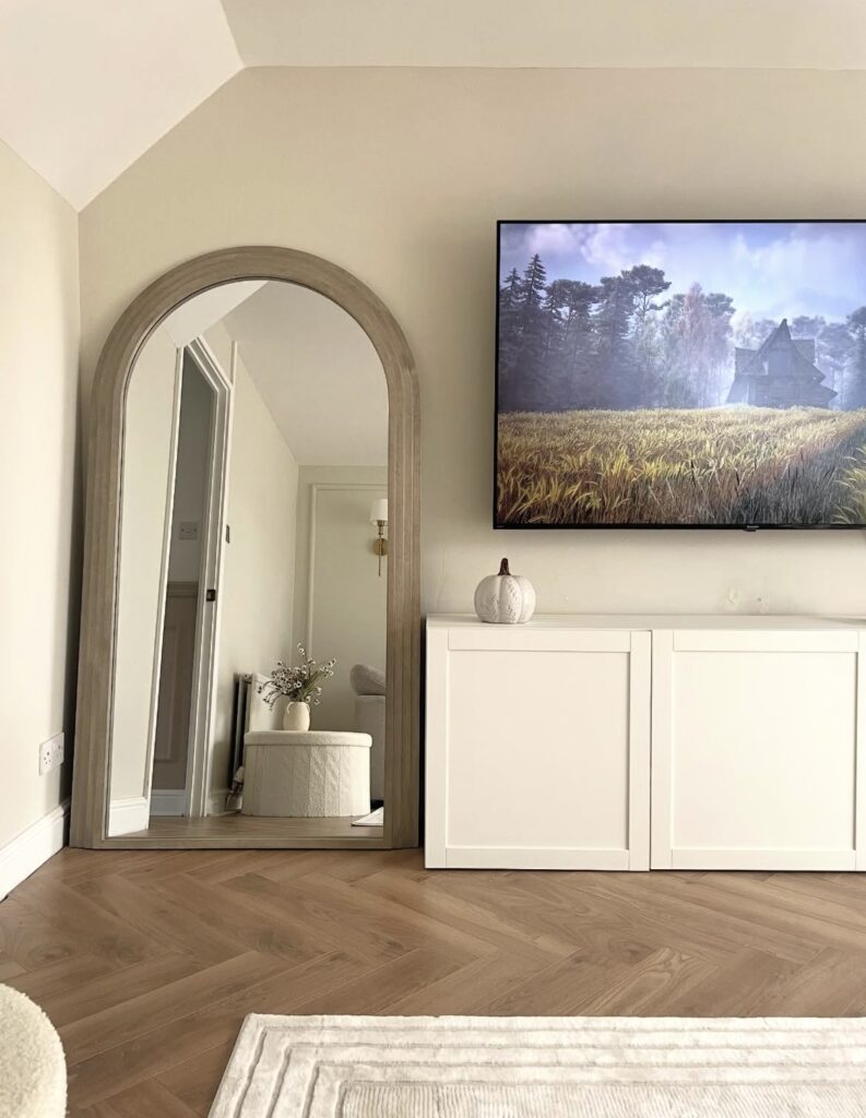 A living room with a mirror.